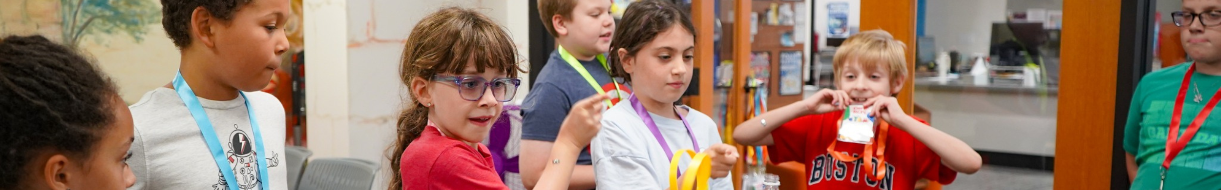 Children's header image showing a group of children during a craft event