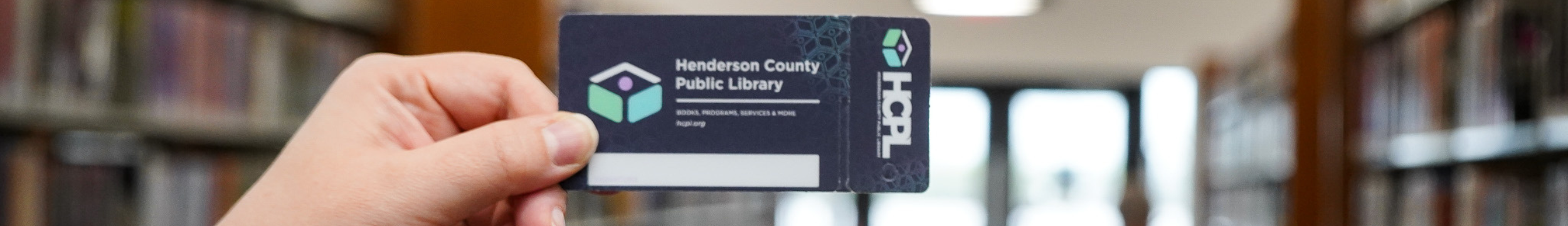 Person holding library card