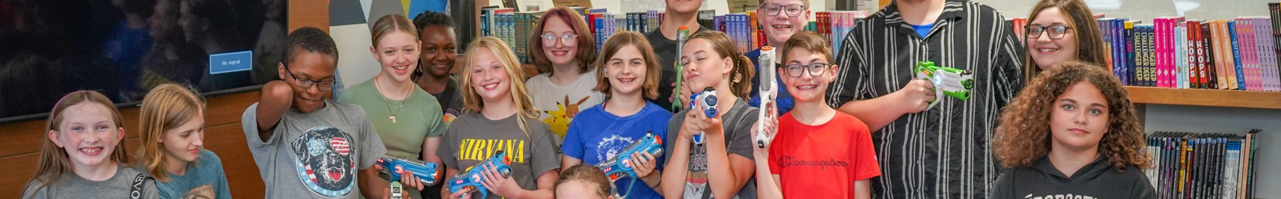Teens header showing a large group of teens in the library