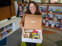 Lady holding a book box in the library