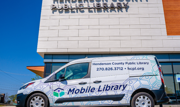 Mobile Library van parked in front of the library building on a sunny day