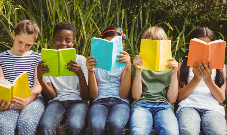 A group of five children holding open books