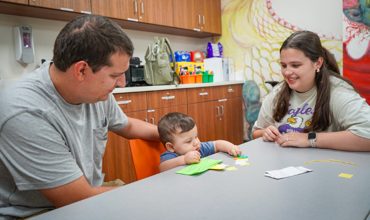 Photo of a family doing a craft together in the messy room